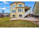 Spacious backyard featuring a patio area, lush green grass, and a two-story home with ample natural light at 2562 S Kendrick St, Denver, CO 80228