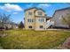 Spacious backyard with mature landscaping and a cozy patio area at 2562 S Kendrick St, Denver, CO 80228