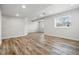 Open layout basement with wood-look floors and recessed lighting at 2562 S Kendrick St, Denver, CO 80228