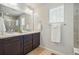 Bathroom featuring double sink vanity with granite countertops and framed mirror at 2562 S Kendrick St, Denver, CO 80228