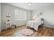 Cozy bedroom with hardwood floors, ample natural light, and playful decor creating an inviting space at 2562 S Kendrick St, Denver, CO 80228