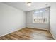 Spare bedroom with hardwood floors, a view from the large window, and plenty of room to make it your own at 2562 S Kendrick St, Denver, CO 80228