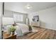 Serene bedroom with wood floors, soft lighting, and neutral decor, creating a relaxing retreat at 2562 S Kendrick St, Denver, CO 80228