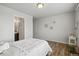 Inviting bedroom featuring hardwood floors and neutral walls, alongside an ensuite bathroom for added convenience at 2562 S Kendrick St, Denver, CO 80228