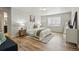 Bright bedroom with neutral tones, a plush bed, and large window for natural light at 2562 S Kendrick St, Denver, CO 80228