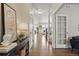Inviting hallway with hardwood floors, leading to a naturally lit living space and staircase at 2562 S Kendrick St, Denver, CO 80228