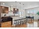 Gourmet kitchen features granite countertops, stainless steel appliances, and a large island with seating at 2562 S Kendrick St, Denver, CO 80228