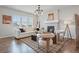 Bright living room with fireplace, neutral decor, and plenty of natural light from large windows at 2562 S Kendrick St, Denver, CO 80228