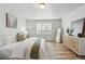 Bright main bedroom with a large window, wood floors, modern decor, and a serene atmosphere at 2562 S Kendrick St, Denver, CO 80228