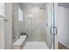 Modern tiled shower with glass door, bench, and sleek fixtures for a spa-like experience at 2562 S Kendrick St, Denver, CO 80228