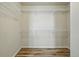 Empty walk-in closet with hardwood floors and white shelving awaiting personalization and organization at 2562 S Kendrick St, Denver, CO 80228