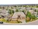 An aerial view of a beautiful home with a tiled roof, stone accents, landscaping, and in a quiet neighborhood at 2571 Hunters Pl, Highlands Ranch, CO 80129