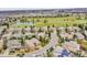 An aerial view of houses in a neighborhood, located adjacent to a beautiful golf course and pond at 2571 Hunters Pl, Highlands Ranch, CO 80129