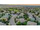 Beautiful aerial view of a suburban neighborhood with mature trees, winding roads, and golf course near mountain background at 2571 Hunters Pl, Highlands Ranch, CO 80129