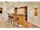 Stylish home bar with pendant lighting, wine fridge, and counter seating for entertaining at 2571 Hunters Pl, Highlands Ranch, CO 80129