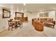 Finished basement with living area, dining set, and home bar for entertaining guests at 2571 Hunters Pl, Highlands Ranch, CO 80129
