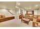 Finished basement with built-in seating, dining area, bar, and comfortable living space at 2571 Hunters Pl, Highlands Ranch, CO 80129