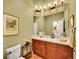 Cozy bathroom features a vanity with wood cabinets and framed print hanging on the wall at 2571 Hunters Pl, Highlands Ranch, CO 80129