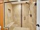 Modern bathroom featuring a tiled shower with a glass door and built-in bench at 2571 Hunters Pl, Highlands Ranch, CO 80129