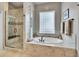Luxurious bathroom with a glass-enclosed shower and soaking tub at 2571 Hunters Pl, Highlands Ranch, CO 80129