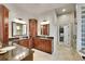 Elegant bathroom with dual sinks, granite countertops, and custom cabinetry at 2571 Hunters Pl, Highlands Ranch, CO 80129