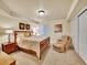 Bedroom boasts a comfortable queen-size bed, soft carpeting, and cozy armchair with ottoman at 2571 Hunters Pl, Highlands Ranch, CO 80129