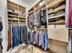 Walk-in closet with custom shelving and ample storage space for clothes and shoes at 2571 Hunters Pl, Highlands Ranch, CO 80129