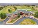 View of community clubhouse on beautifully landscaped grounds with ample parking for patrons and service vehicles at 2571 Hunters Pl, Highlands Ranch, CO 80129