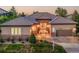Charming single-story home featuring stone accents, a tile roof, and a well-manicured lawn at 2571 Hunters Pl, Highlands Ranch, CO 80129