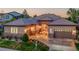 Charming single-story home featuring stone accents, a tile roof, and a well-manicured lawn at 2571 Hunters Pl, Highlands Ranch, CO 80129