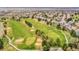 Aerial view of a lush golf course with mature trees lining the fairways and well-manicured greens at 2571 Hunters Pl, Highlands Ranch, CO 80129