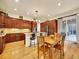 Bright kitchen with a central island, stainless steel appliances, and an adjacent dining area at 2571 Hunters Pl, Highlands Ranch, CO 80129