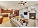 Cozy living room with fireplace and views of the kitchen and dining area at 2571 Hunters Pl, Highlands Ranch, CO 80129