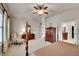 Spacious main bedroom with a ceiling fan, plush carpet, and a well-lit ensuite bathroom at 2571 Hunters Pl, Highlands Ranch, CO 80129