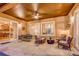 Covered outdoor patio featuring stone flooring, a ceiling fan, and comfortable seating arrangements at 2571 Hunters Pl, Highlands Ranch, CO 80129