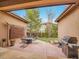 Charming patio setup with outdoor seating, grill, and view of the lush backyard at 2571 Hunters Pl, Highlands Ranch, CO 80129