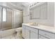 Bathroom featuring vanity, tile floors and shower enclosure with a glass sliding door at 7000 E Quincy Ave # 204, Denver, CO 80237
