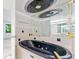 Bathroom featuring a black soaking tub, mirrors, tile accents, and hardware at 7000 E Quincy Ave # 204, Denver, CO 80237