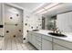 Bathroom with double sink vanity, black and white tile, and glass enclosed shower at 7000 E Quincy Ave # 204, Denver, CO 80237