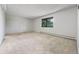 Bright bedroom featuring neutral carpet, a window, and a baseboard heater at 7000 E Quincy Ave # 204, Denver, CO 80237