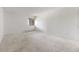 A neutral-toned bedroom featuring a large window and carpeted floors at 7000 E Quincy Ave # 204, Denver, CO 80237