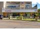 Commercial building featuring modern architecture, multiple businesses, landscaping, and ample parking at 7000 E Quincy Ave # 204, Denver, CO 80237