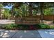 Promontory community sign with brick surround, beautiful foliage, and a glimpse of the community entrance at 7000 E Quincy Ave # 204, Denver, CO 80237