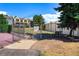 Gated dog park features shady trees, a bench, and easy access to nearby residences in a pet-friendly community at 7000 E Quincy Ave # 204, Denver, CO 80237