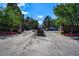 The Promontory entrance gate, secured with black iron fencing, surrounded by beautiful flower beds and greenery at 7000 E Quincy Ave # 204, Denver, CO 80237