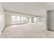 Large living room with neutral carpet, recessed lights, and unique window at 7000 E Quincy Ave # 204, Denver, CO 80237