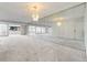 Open-concept living area featuring chandelier lighting and mirror wall at 7000 E Quincy Ave # 204, Denver, CO 80237