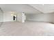 Bright living room features neutral carpet, recessed lighting, and mirrored wall for an open feel at 7000 E Quincy Ave # 204, Denver, CO 80237