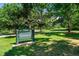 Sign for Eastmoor Park amid lush greenery and trees at 7000 E Quincy Ave # 204, Denver, CO 80237