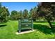 Sign for George M. Wallace Park amid lush greenery and trees at 7000 E Quincy Ave # 204, Denver, CO 80237